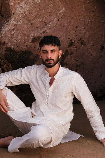 Side view of the ivory white embroidered kurta pajama highlighting its elegant fit and craftsmanship.